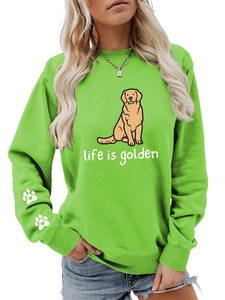Close-up of cute golden retriever print and white paw pattern on green crewneck sweatshirt
