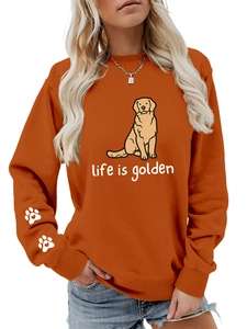 Close-up of heart paw print on sleeve and golden retriever print on orange sweatshirt