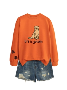 Detail of orange sweatshirt with Life is Golden dog print and paw icons on sleeves