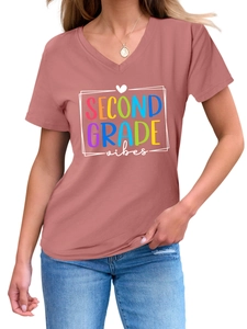 Detail of pink V-neck T-shirt featuring a colorful Second Grade Vibes printed slogan