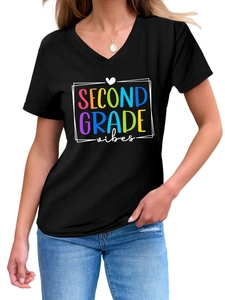 Detail of V-neck T-shirt showing colorful Second Grade Vibes print on black fabric
