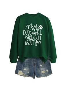 Flat lay of dark green crewneck sweatshirt with dog humor text and denim shorts