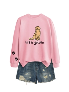 Detail view of pink sweatshirt with golden retriever print and distressed denim shorts