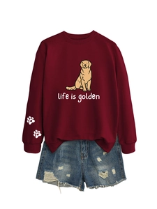 Detail of burgundy sweatshirt with dog print, life is golden text and paw sleeve pattern
