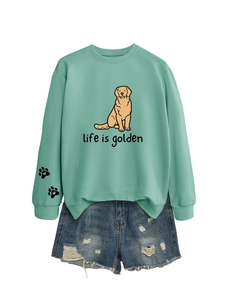 Detail of mint green sweatshirt with Life is Golden print and paw detail on sleeve