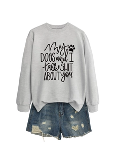 Close-up of grey sweatshirt with 'My dogs and I talk shit' print and ripped denim shorts