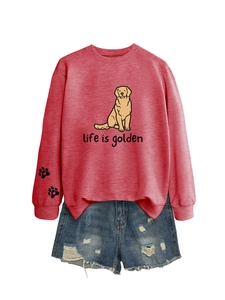 Flat lay of pink 'Life is Golden' sweatshirt with sleeve prints and denim shorts