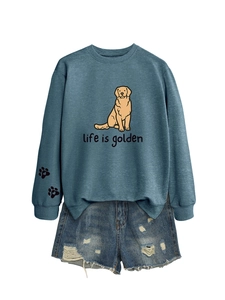 Flat lay of a blue crewneck sweatshirt with golden retriever print and denim shorts
