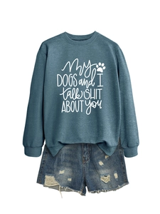 Flat lay of gray sweatshirt with dog theme slogan and distressed denim shorts