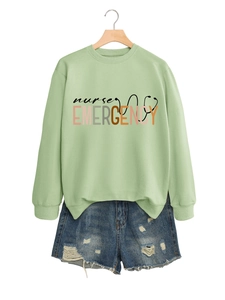 Détail du sweat vert avocat avec imprimé Nurse Emergency et short en jean assorti