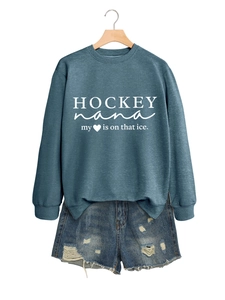 Details des petrolfarbenen Hockey-Sweatshirts mit zerrissenen Jeans-Shorts am Bügel