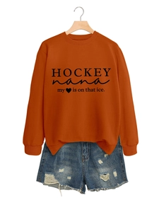 Details des orangen Hockey-Nana-Sweatshirts mit Slogan und Used-Look-Jeansshorts