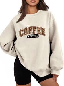 Close-up of Coffee Weather lettering print on soft oatmeal oversized sweatshirt