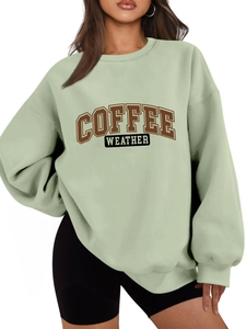 Detail of light green sweatshirt featuring Coffee Weather graphic print and ribbed collar