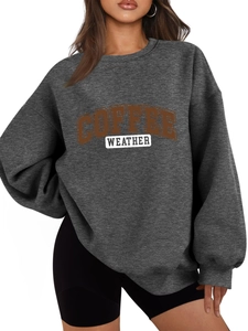 Detail of loose dark grey sweatshirt with textured Coffee Weather lettering print