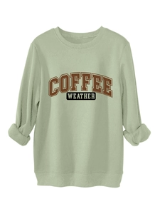 Detailed view of the ribbed cuffs and COFFEE WEATHER print on the sage green sweatshirt