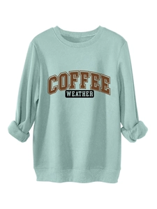 Close-up of ribbed neckline and Coffee Weather print on mint green sweatshirt