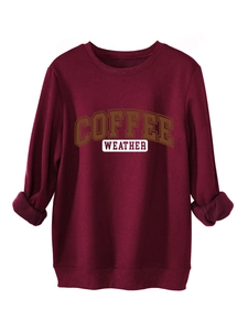Detail view of burgundy sweatshirt showing warm fleece lining and Coffee Weather print