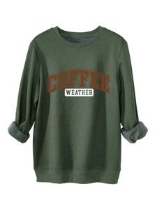 Detail of dark green sweatshirt showing inner fleece texture and coffee weather print