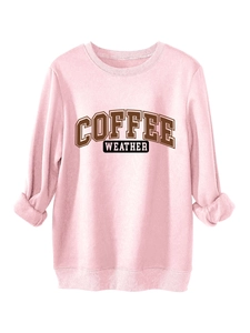 Close-up of pink oversized sweatshirt with Coffee Weather print and folded cuffs detail