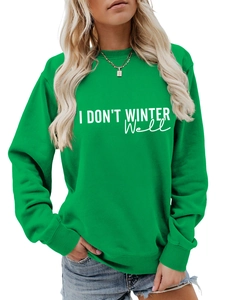 Detail of green crewneck sweatshirt with I DON'T WINTER WELL print on cotton fabric