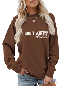 Detail of white I DON'T WINTER WELL artistic text printed on a dark brown cozy sweatshirt