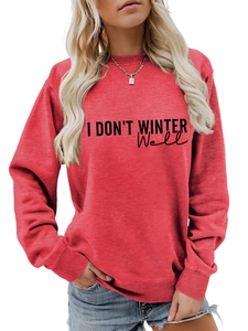 Close-up detail of I DON'T WINTER WELL artistic text on red casual crewneck sweatshirt