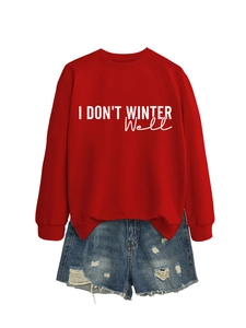 Flat lay of red pullover sweatshirt with white text and ripped denim shorts