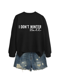 Flat lay of black I DON'T WINTER WELL sweatshirt and distressed denim shorts