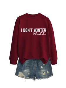 Close-up of ribbed cuffs and white text print on a burgundy casual sweatshirt