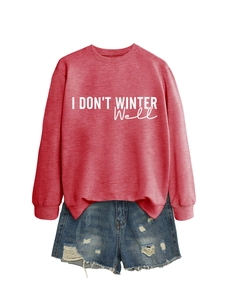 Detail of red sweatshirt with 'I DON'T WINTER WELL' print and distressed denim shorts