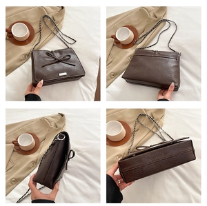 Detail views of brown faux leather crossbody bag with lychee texture and bow accent