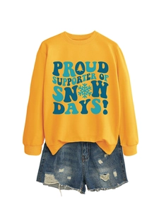 Détail du sweat jaune avec imprimé Proud Supporter of Snow Days et short en jean
