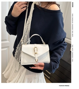 White PU leather handbag with elegant lace strap and gold hardware detail on model