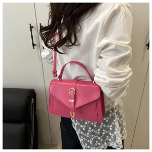 Magenta square handbag for women featuring golden U-shaped clasp and adjustable strap