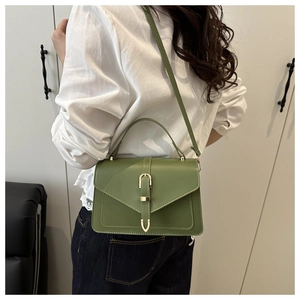 Green faux leather rectangular crossbody bag shown on model back for size reference