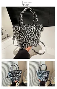 Close-up of black and white leopard print bucket bag with polished PU leather and metal hooks