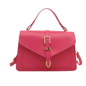 Fuchsia PU leather handbag with gold horseshoe buckle and adjustable crossbody strap