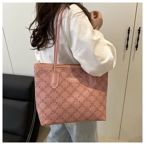 Detailed close-up of pink cherry blossom patterned tote bag with slim shoulder straps