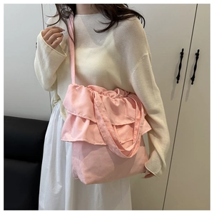 Detail of pink canvas tote bag showing double-layered ruffle pleats and soft fabric texture