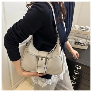 Detail of grey half-moon underarm bag with retro metal buckle and front zip pockets