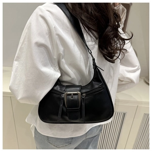 Retro black crescent underarm bag with silver buckle worn by model in casual outfit
