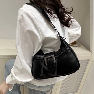 Minimalist black crescent shoulder bag with vintage silver metal buckle and side tassels