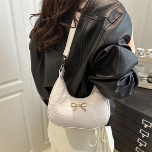 Chic light gray crescent shoulder bag with crocodile pattern and golden bow detail