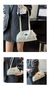 Detail of cream white half-moon shoulder bag with delicate lace bow and metallic logo