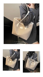 Three-way view of a large beige canvas tote bag with white leather straps and trim details