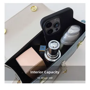 Internal capacity of contrast color crossbody bag showing storage for phone and makeup