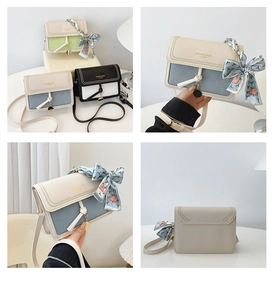Detail of elegant contrast color crossbody bag with silk scarf bow and gold logo text