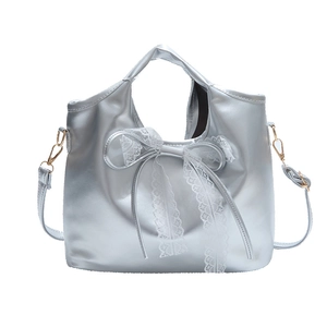 Silver metallic shoulder bag with large bow and lace trim, vintage bucket style with strap