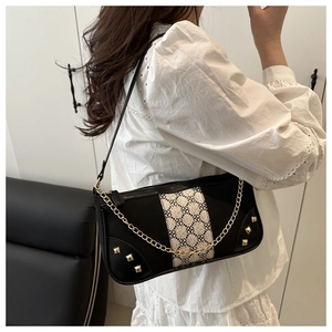 Detail of vintage square shoulder bag with jacquard pattern and golden chain strap